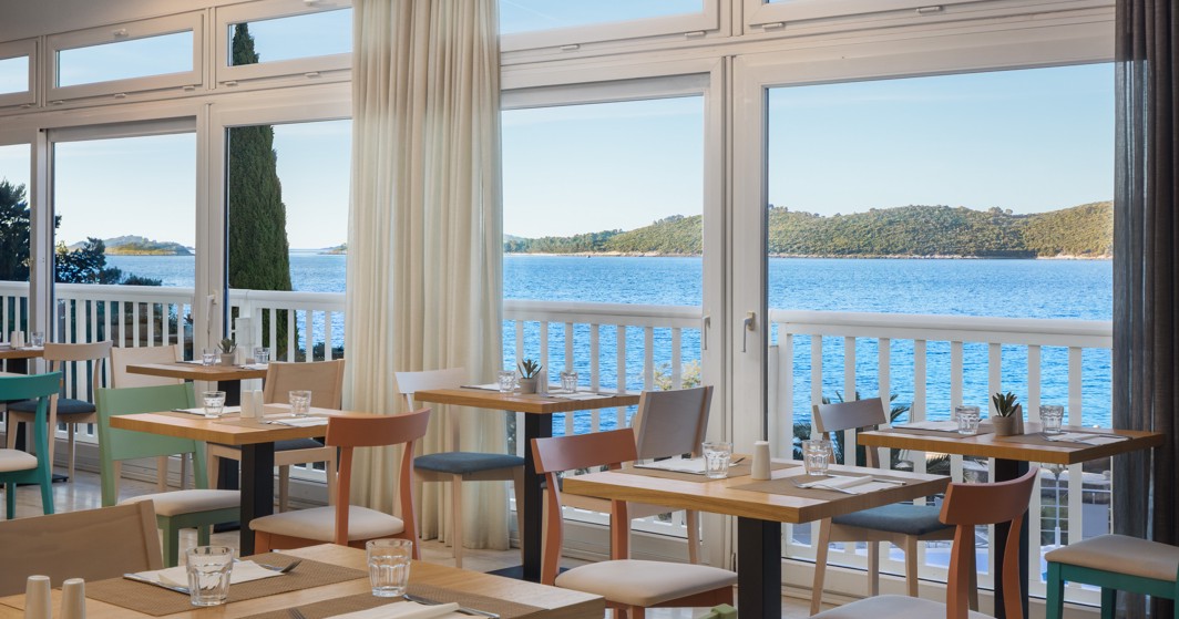 Restaurant at Orsan Maradiso Hotel by Aminess with a sea view.