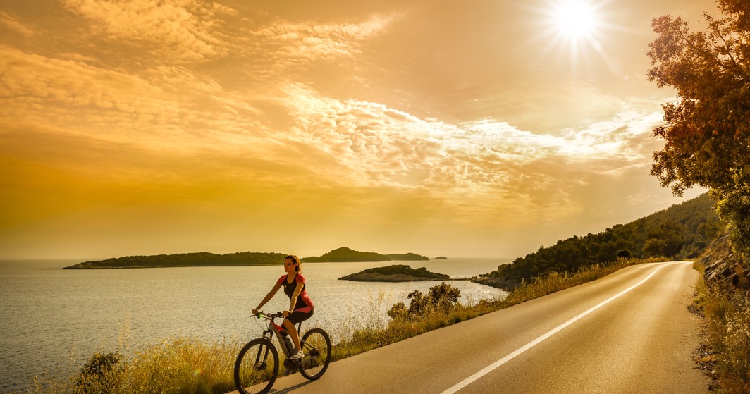 Scenic bike ride along Korcula's coastal paths near Aminess Younique Liburna Hotel.