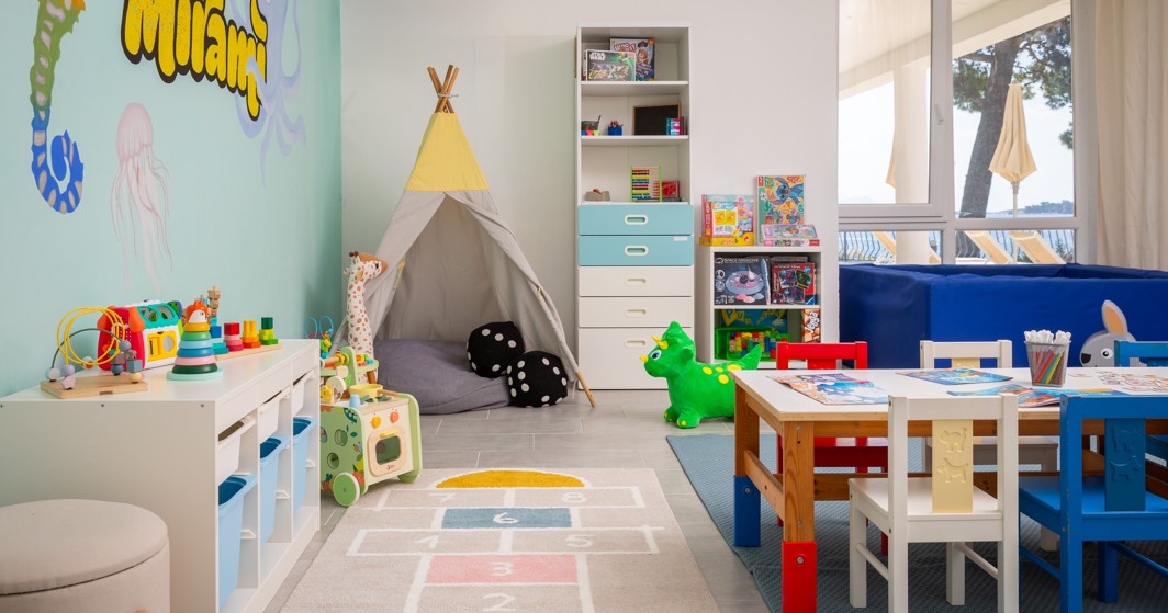 Mini club playroom at Younique Bellevue Hotel by Aminess with a teepee and toys.