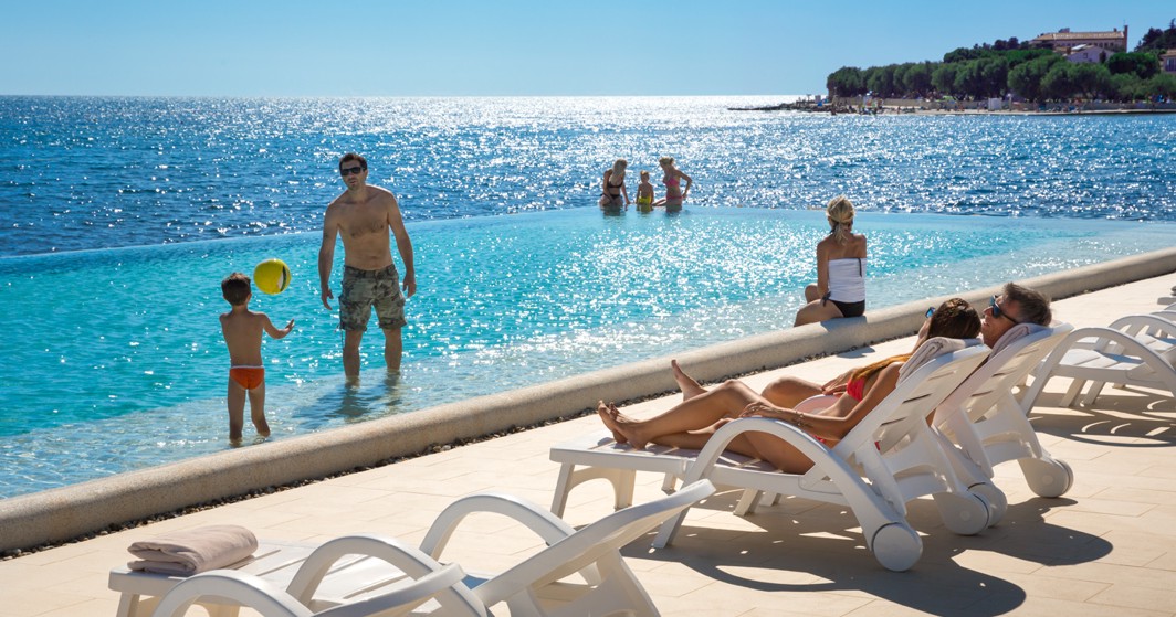 Family at the pool with sun loungers at Aminess Maradiso Hotel Laguna, Novigrad