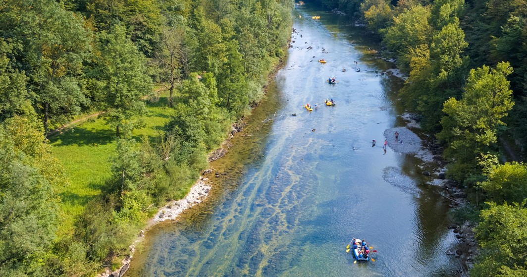 Rafting on the Kupa River surrounded by dense green forest near Karlovac.