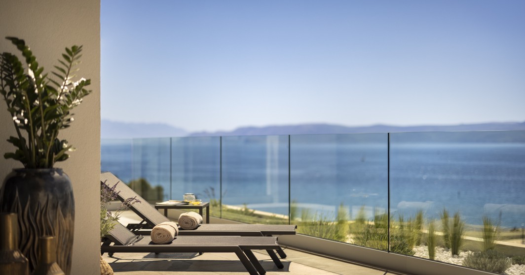 Relaxing outdoor pool terrace with panoramic sea views at Aminess Younique Narrivi Hotel in Crikvenica, Croatia.