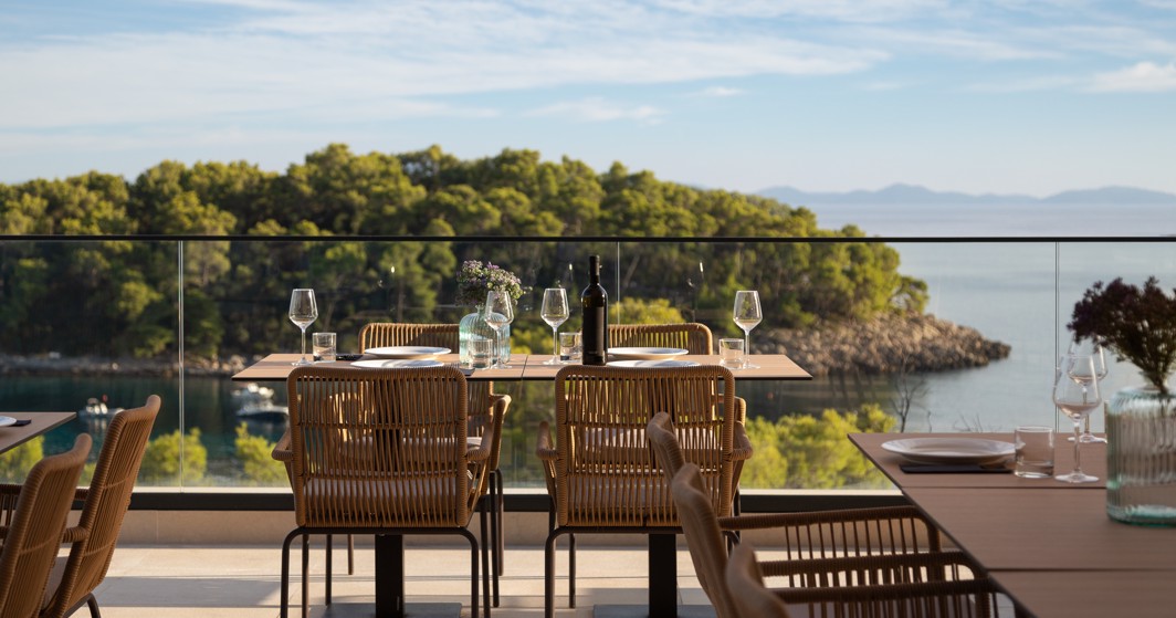 Restaurantterras van Aminess Alfir Resort met gedekte tafels en uitzicht op zee en pijnbomen
