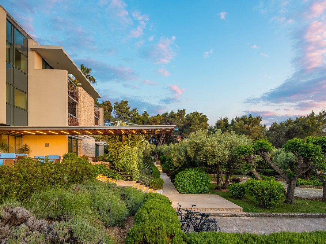 Exterior view of Aminess Vival Velaris Resort on Brač Island surrounded by a Mediterranean garden and lavender