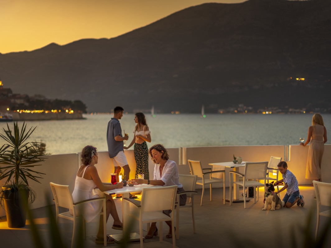 A spacious restaurant terrace with plenty of outdoor seating, cozy, romatic and candlelit dinner at Aminess Younique Liburna Hotel.