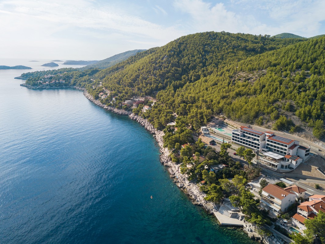 Aerial view of the coastline and natural surroundings near Aminess Alfir Resort by the crystal-clear sea