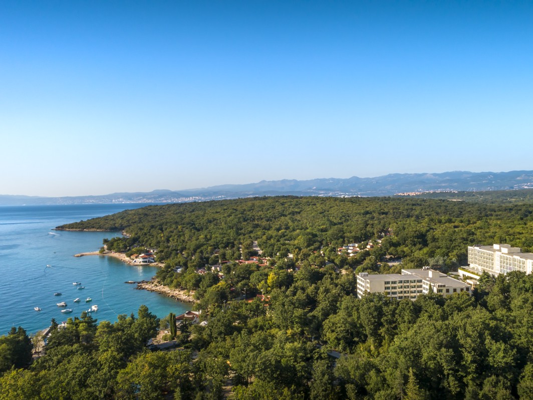 Luchtfoto van Magal Maradiso Hotel by Aminess omgeven door groen en de zee.