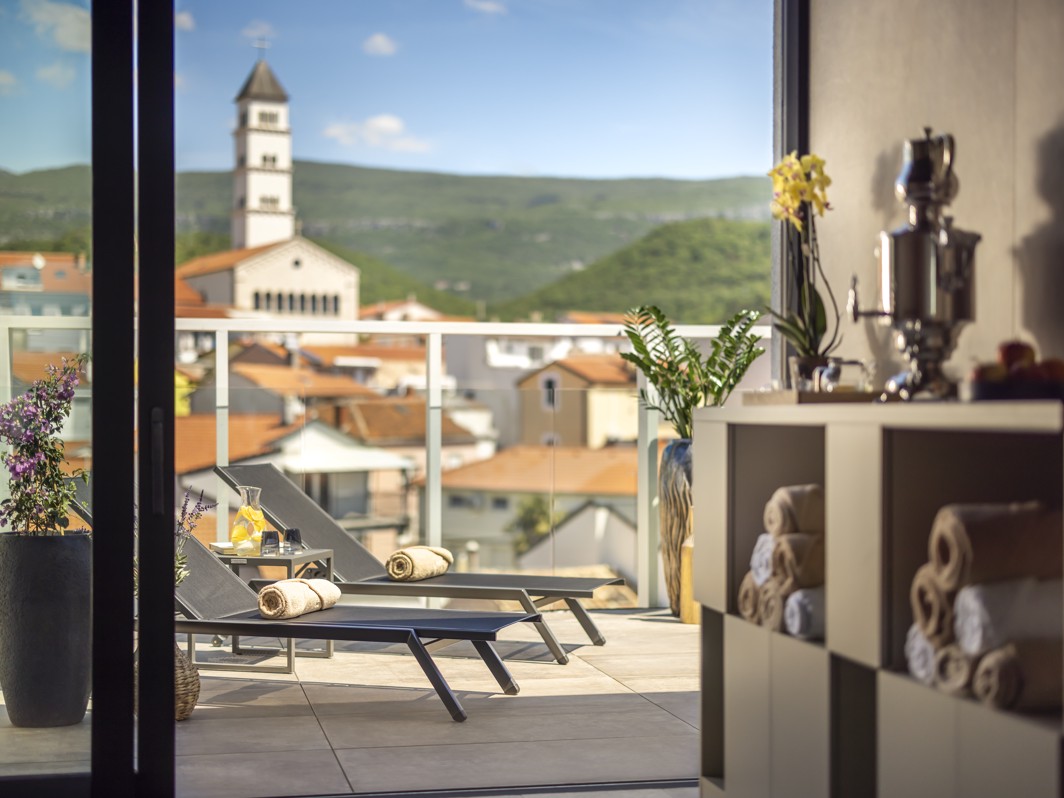 Relaxation room with a terrace view at Aminess Younique Narrivi Hotel.