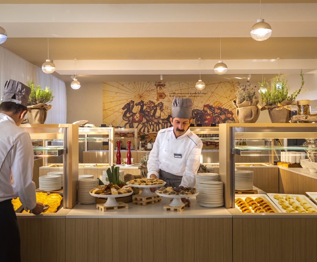 A waiter serving food at the buffet at Aminess Vival Port9 Resort in Korcula.