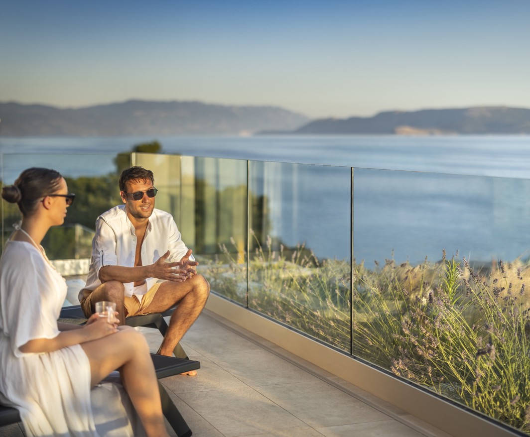 Couple enjoying a sea view from the spa terrace at Aminess Younique Narrivi Hotel.