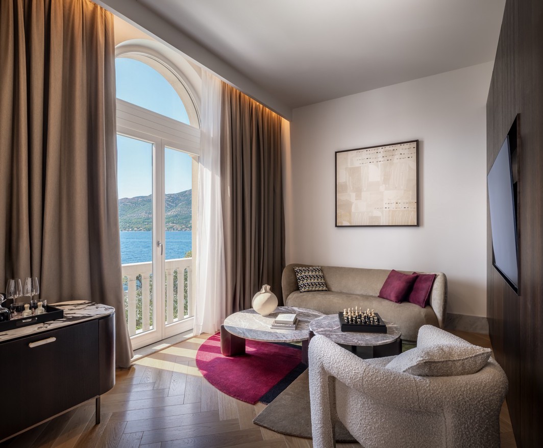 Moderan dnevni boravak Aminess hotelskog apartmana s balkonom i pogledom na more.