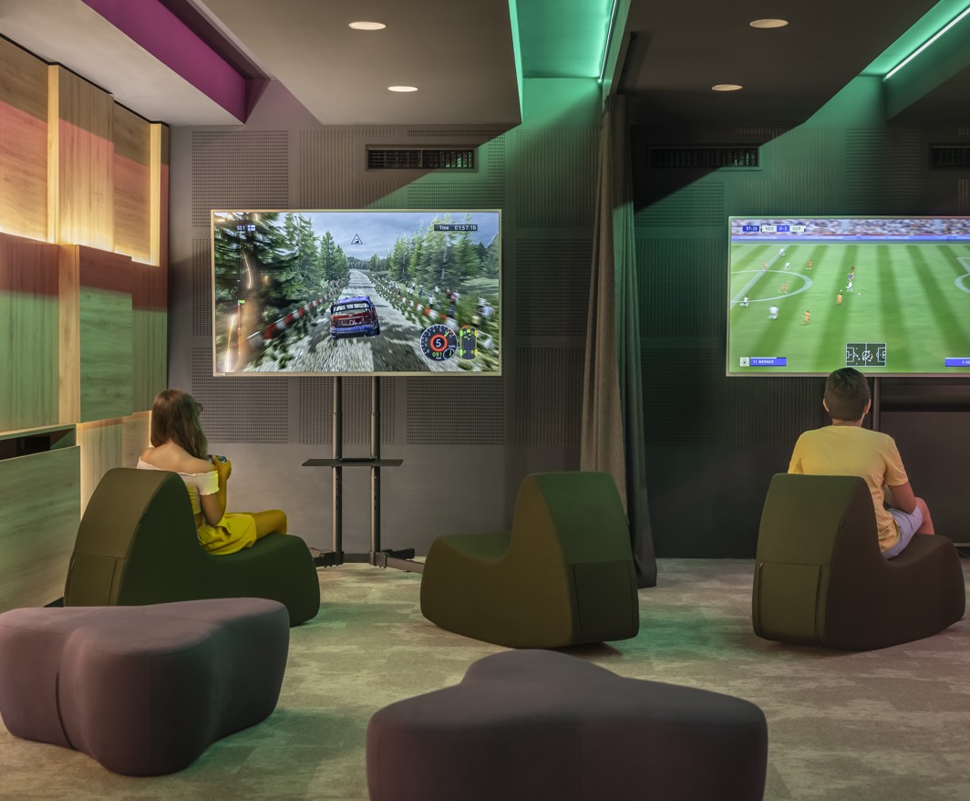 Children play video games in a gaming room during a family holiday in Makarska.