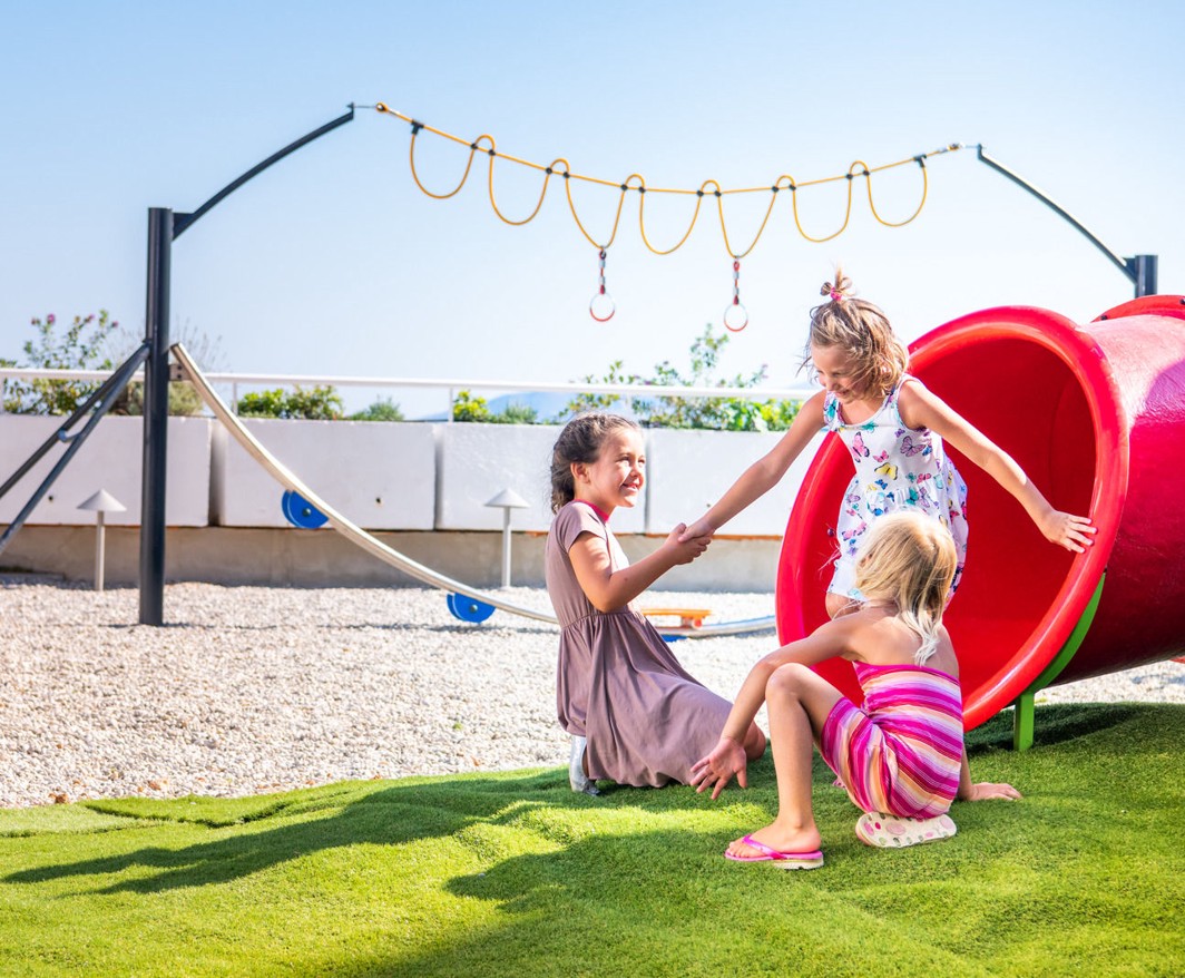 Children playing at the outdoor playground of Aminess Veya Hotel Lišanj