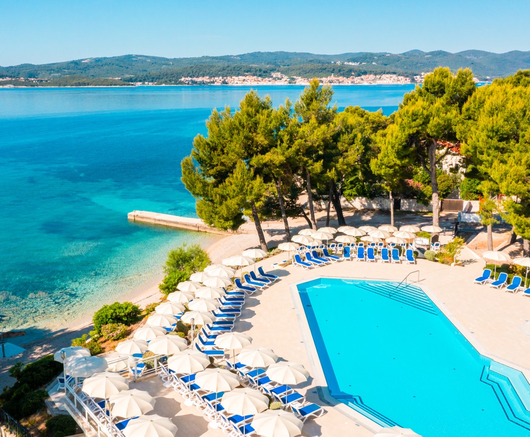 Stunning seaside view of the pool area surrounded by natural beauty at Aminess Vival Grand Azur Hotel.