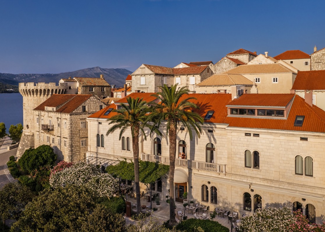 aminess-hotel-historic-stone-building-seafront-palm-trees