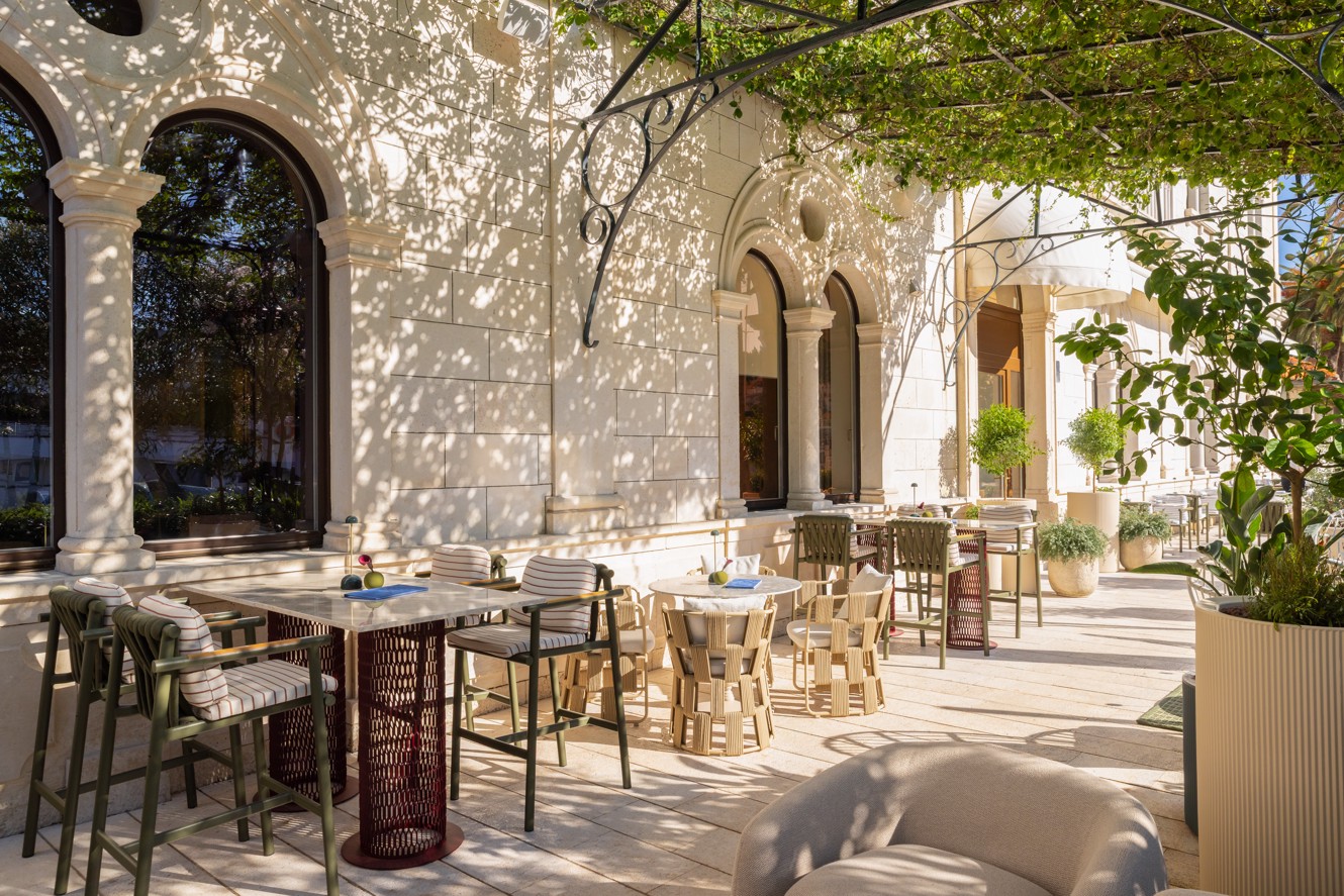 7 Seas bar terrace with elegant tables and Mediterranean greenery