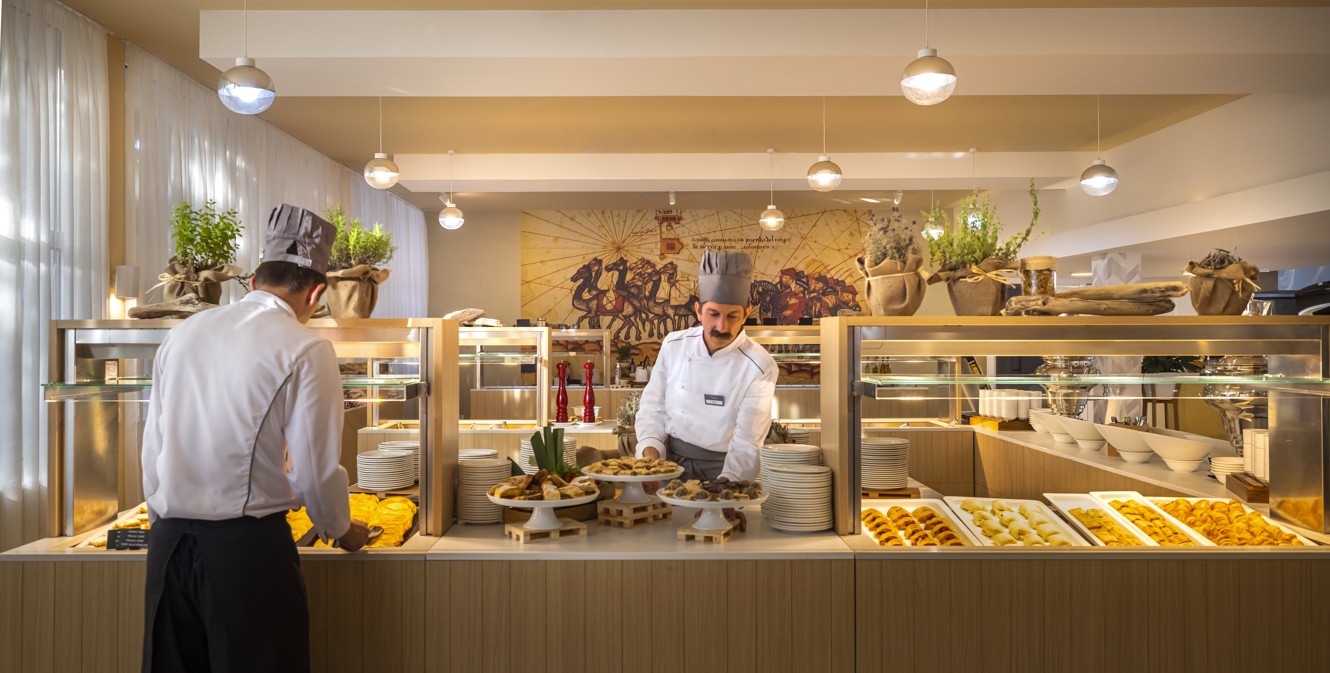 A waiter serving food at the buffet at Aminess Vival Port9 Resort in Korcula.