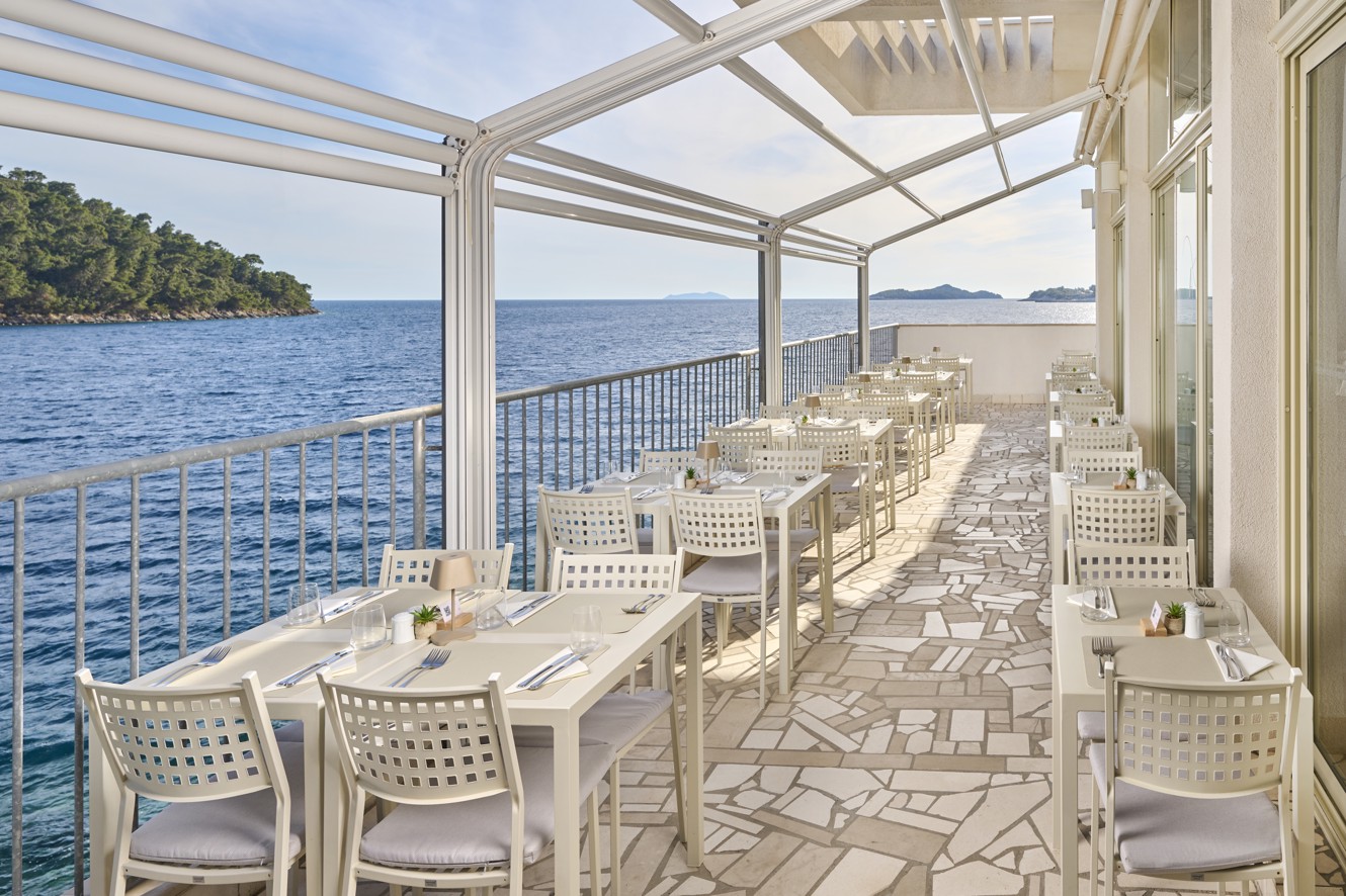 Oceanfront dining table seating at the Aminess Younique Lume Hotel restaurant.