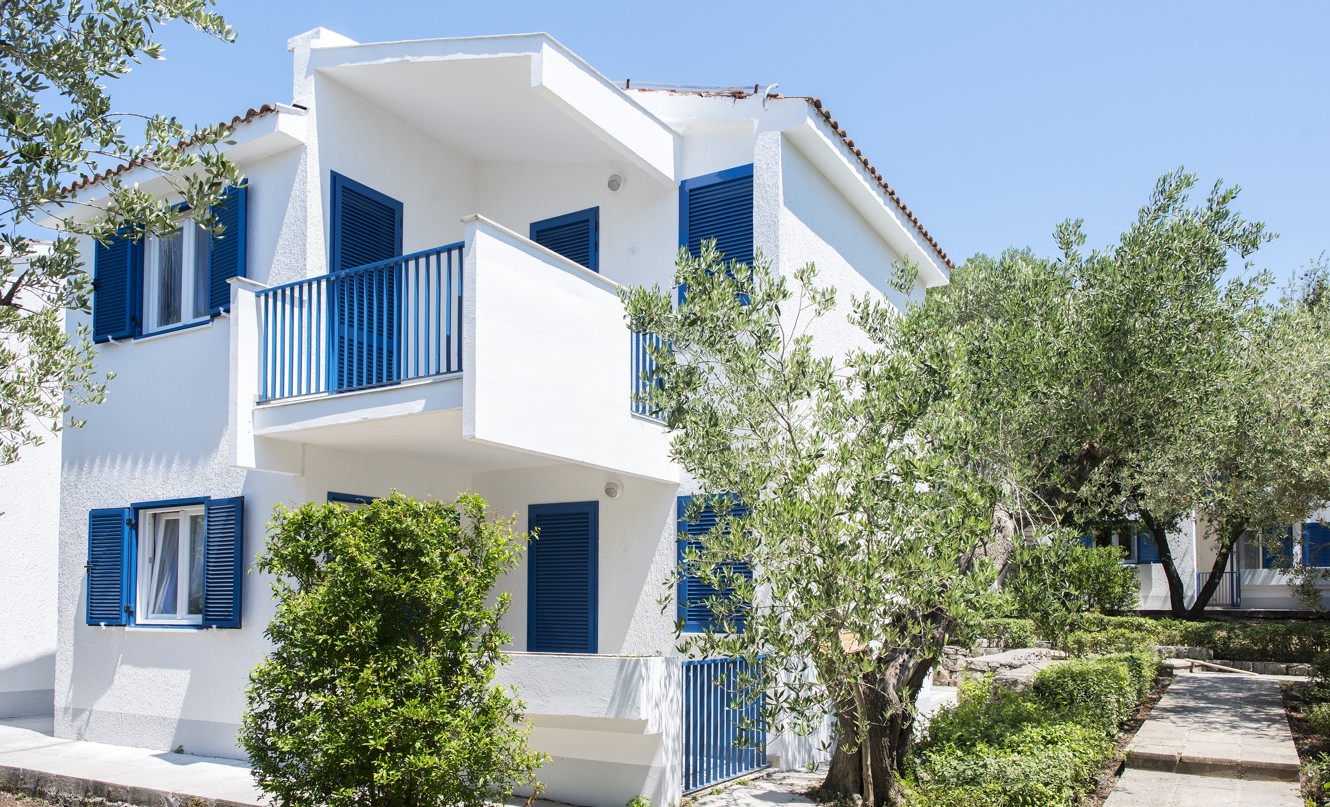 Traditional style buildings surrounded by olive trees at Aminess Vival Port9 Residence.