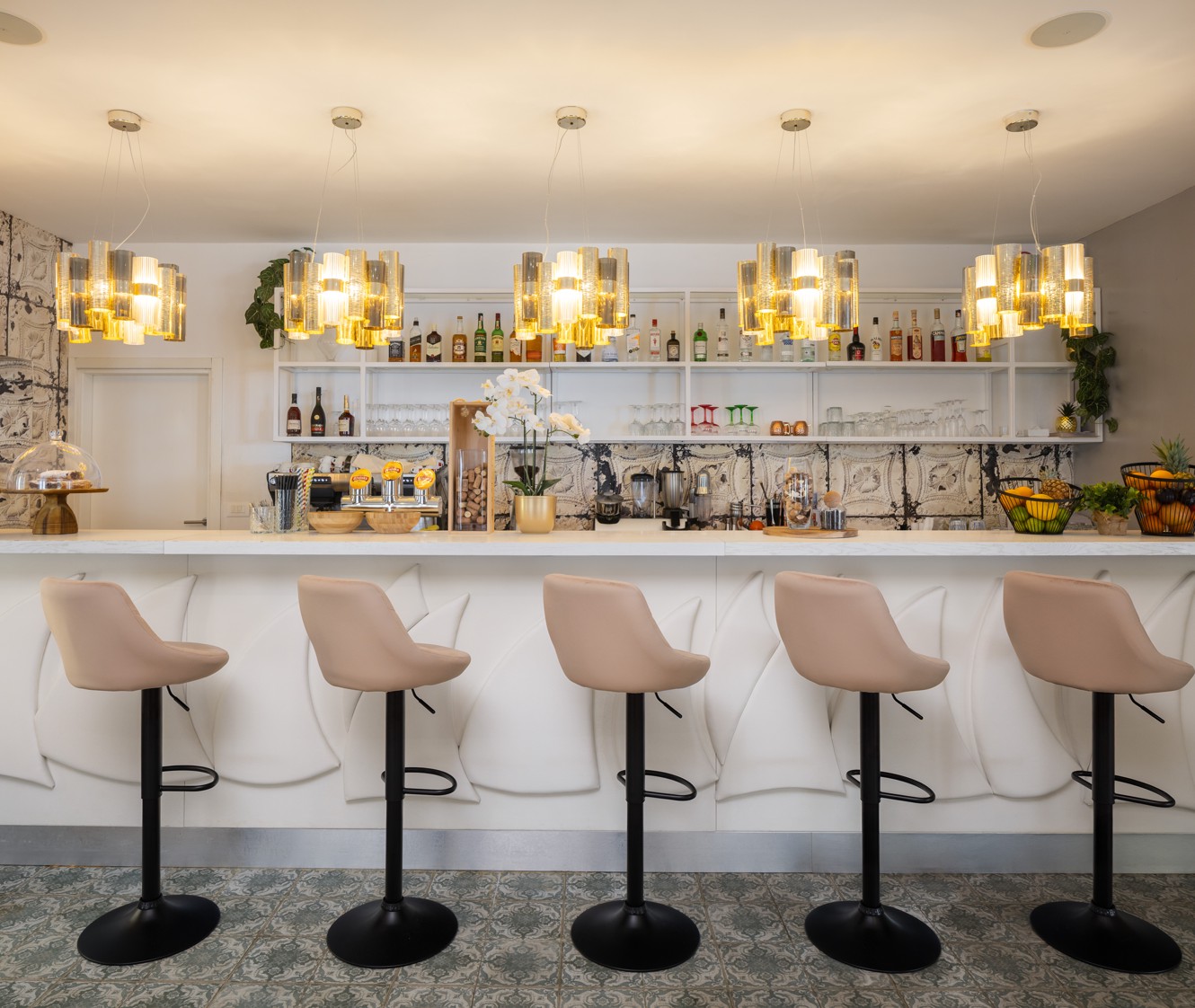 Bar Noir at Younique Bellevue Hotel by Aminess with bar stools and pendant lights.