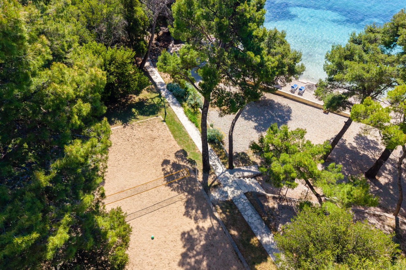 Aerial view of the pine-shaded beach at Aminess Vival Grand Azur Hotel.