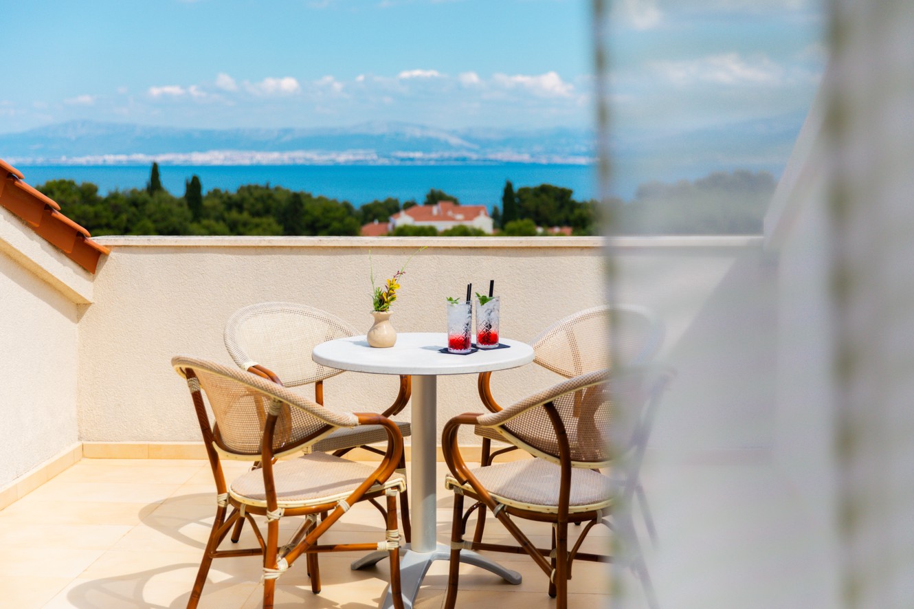 Private sea-view balcony of the duplex suite at Aminess Vival Valeris Resort, with round table and refreshing drinks