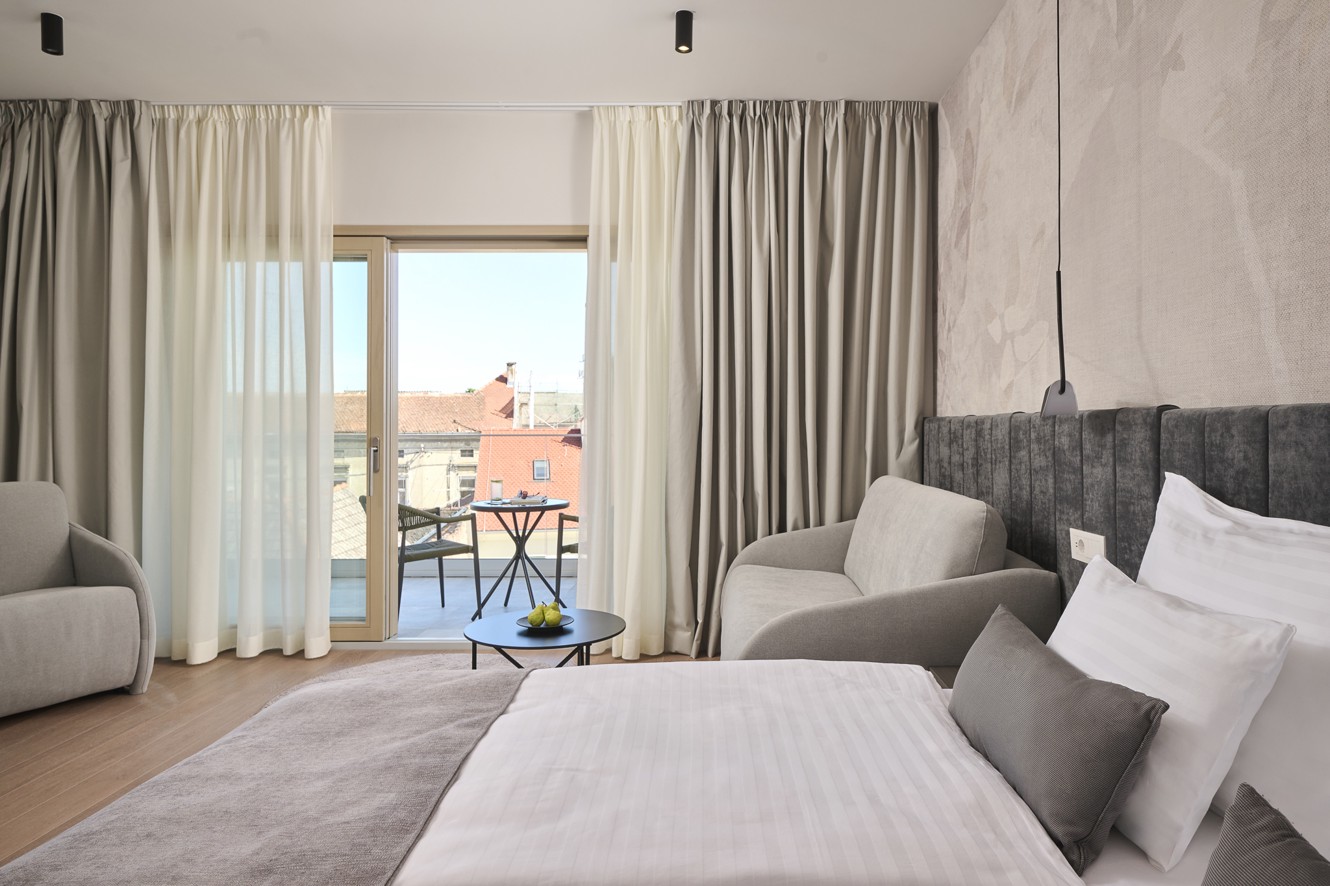 Deluxe room at Aminess Florian Godler Hotel with balcony view.