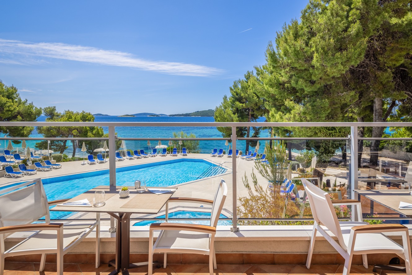 Restaurant terrace at Aminess Vival Grand Azur Hotel overlooking the pool and sea.