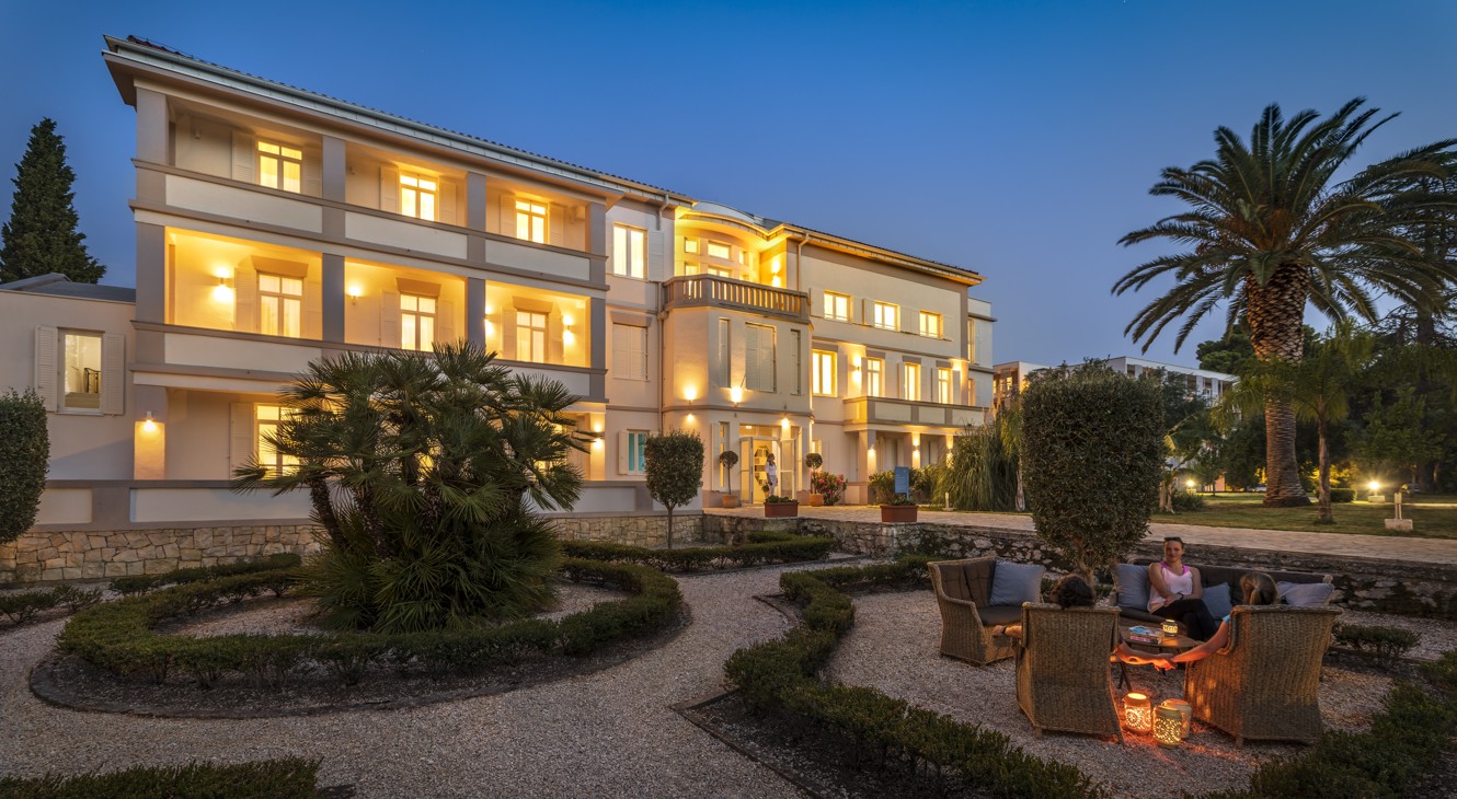 Melion hotel building surrounded by gardens in the night ambience at Aminess Vival Port9 Resort.