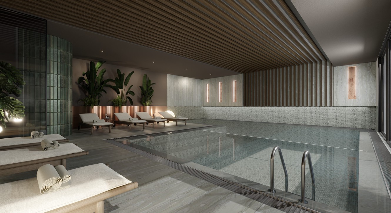 Indoor hotel pool in wellness area with loungers for relaxation