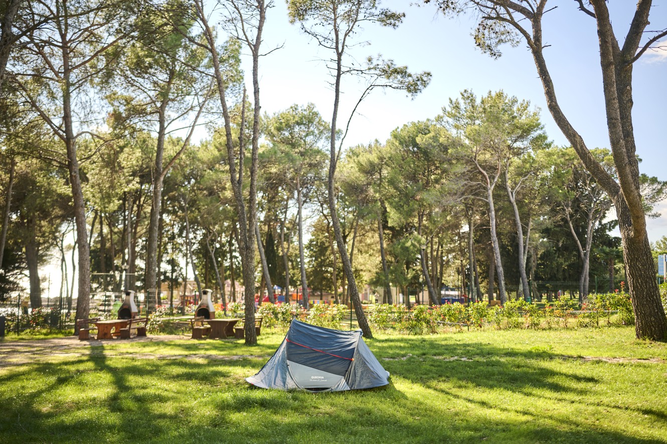Pitch at Aminess Planet Camping Sirena Holiday Homes, featuring a tent and green grass, perfect for relaxation