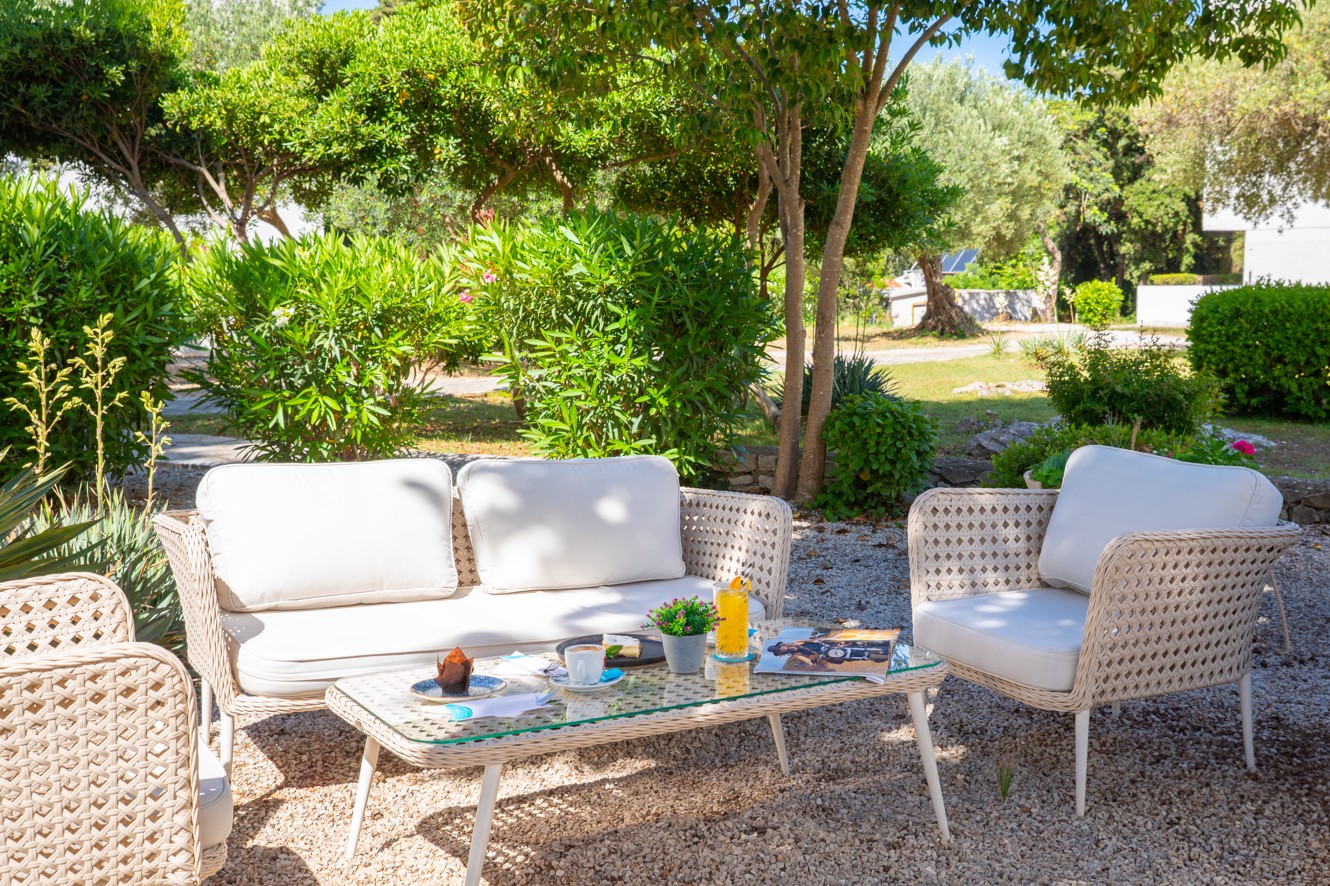 Relaxing lounge set in the shade of Gusto Bar at the Aminess Vival Port9 Resort.