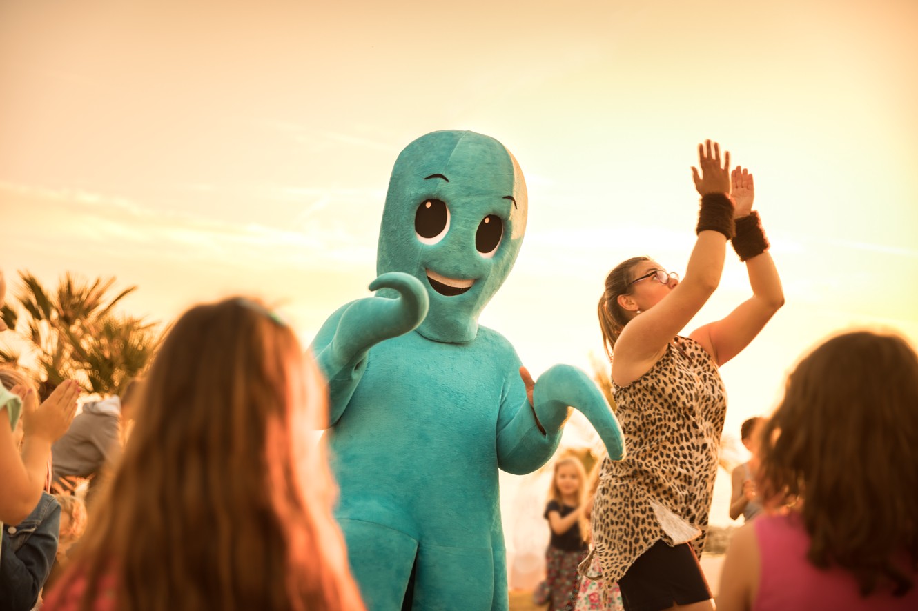 Mirami macote dancing with kids outdoors during Mirami Mini Disco session at the Aminess Vival Grand Azur Hotel.