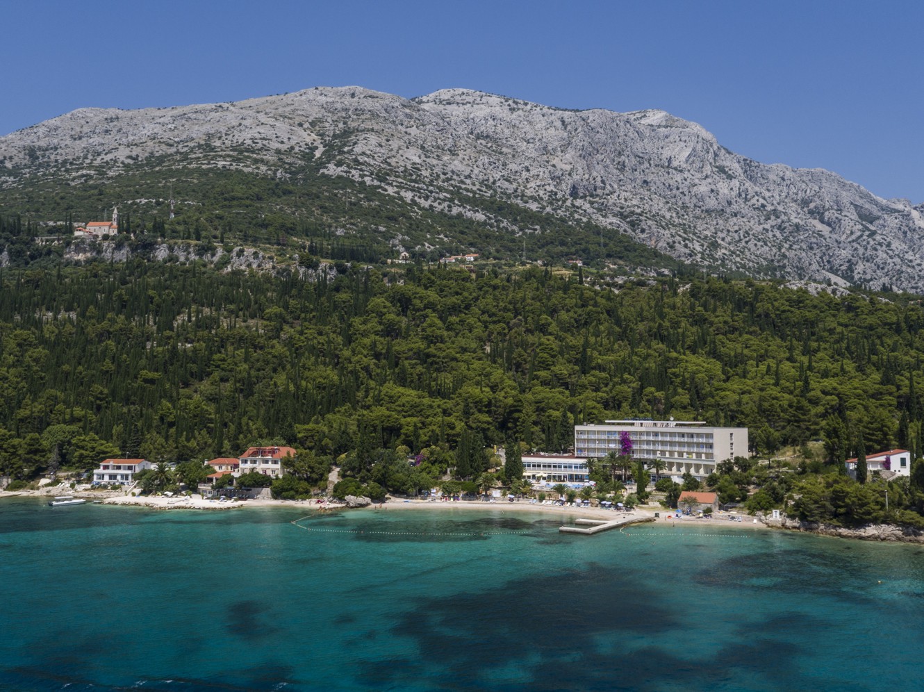 Exterieur uitzicht op Aminess Maradiso Orsan Hotel in Orebic, genesteld door een beboste berg en met uitzicht op de Adriatische Zee