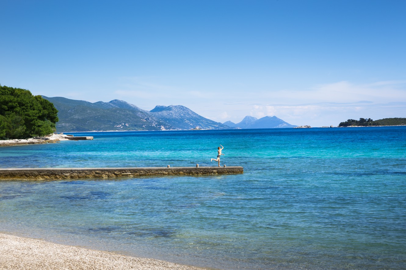 A peaceful pebble beach next to Aminess Maradiso Bellevue Village.