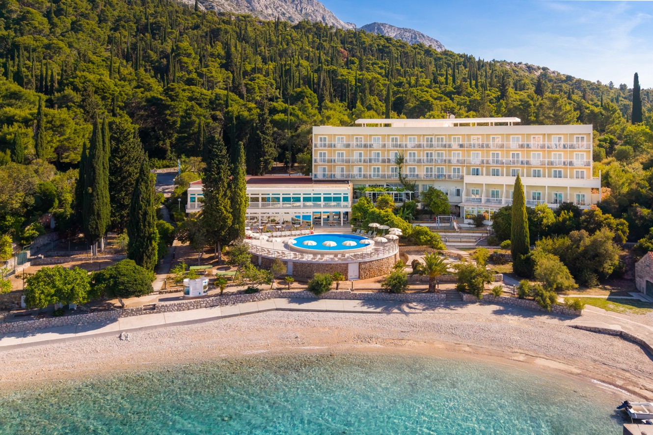 Orsan Maradiso Hotel by Aminess beside the beach, pool and forested mountain.