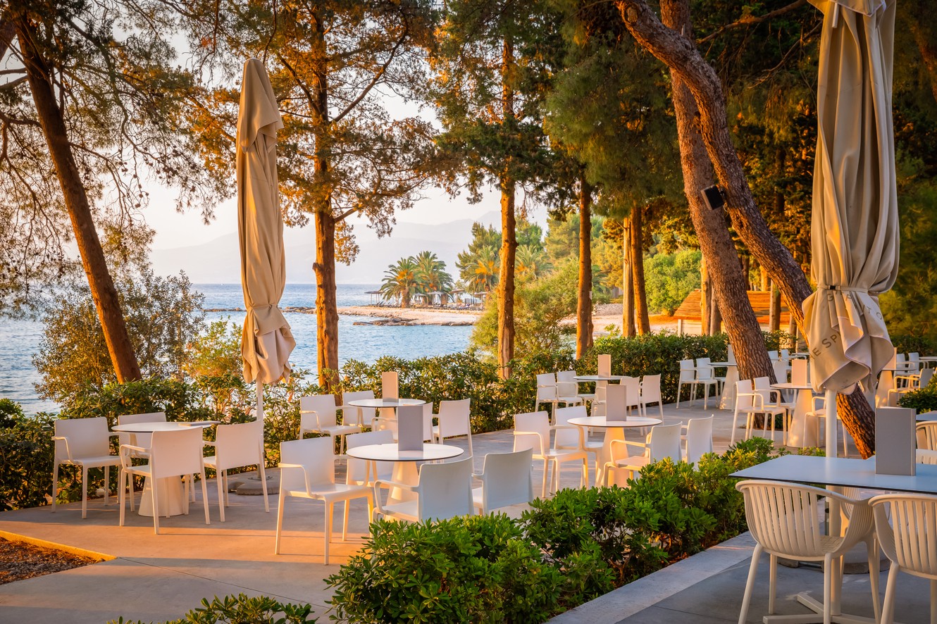 Punto Mare restaurant terrace shaded by pine trees, with sea and island view, Aminess Vival Velaris Resort, Brač