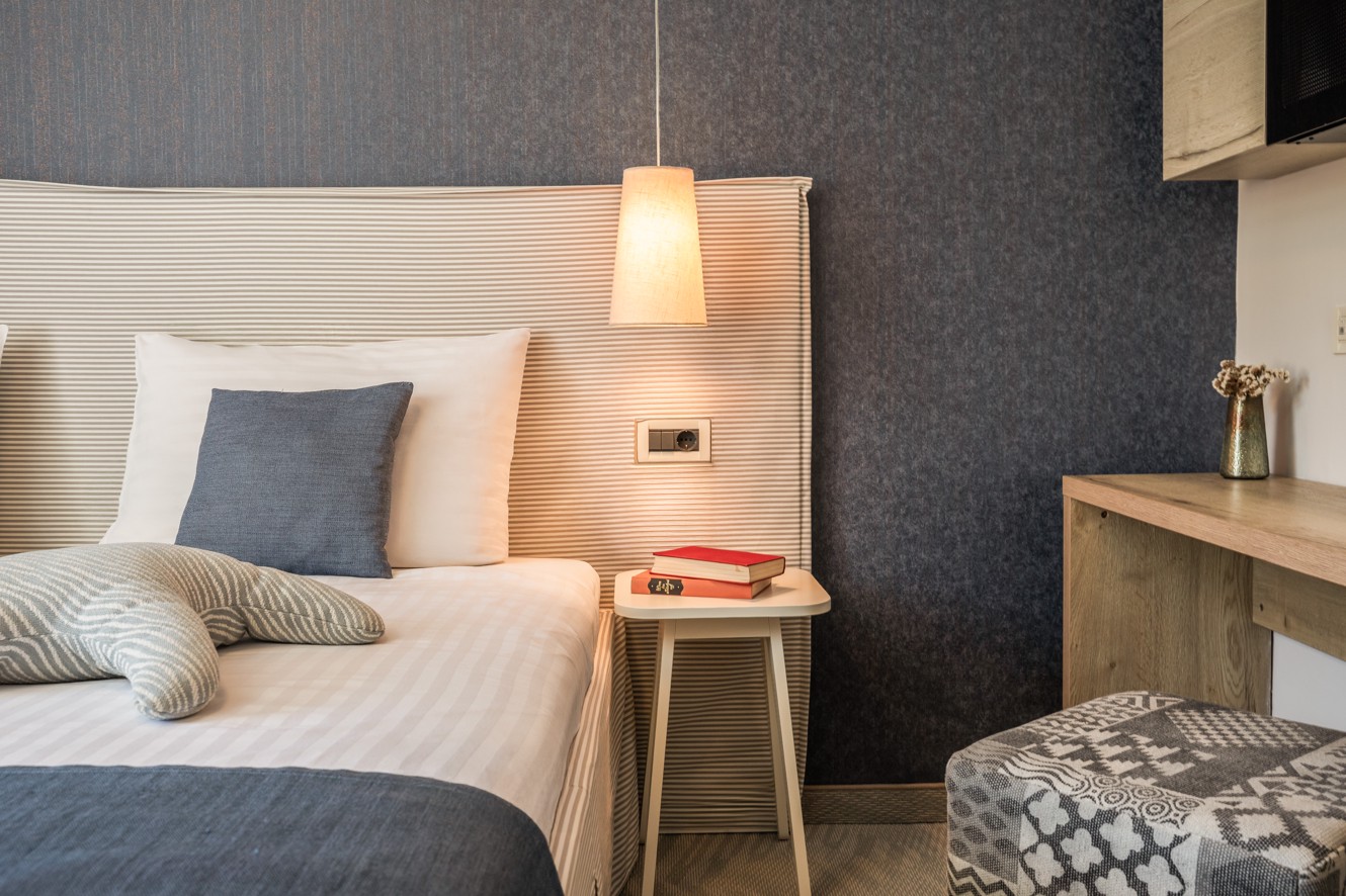 Detail of double room with bedside lamp at Aminess Lume Hotel