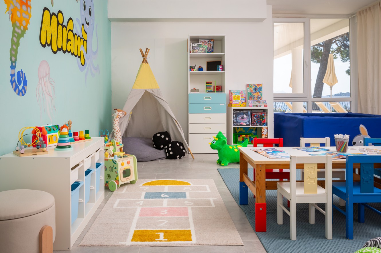 Mini club playroom at Younique Bellevue Hotel by Aminess with a teepee and toys.
