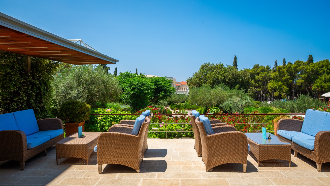 Outdoor lounge area of the lobby bar at Aminess Vival Velaris Resort on Brač with garden and nature view