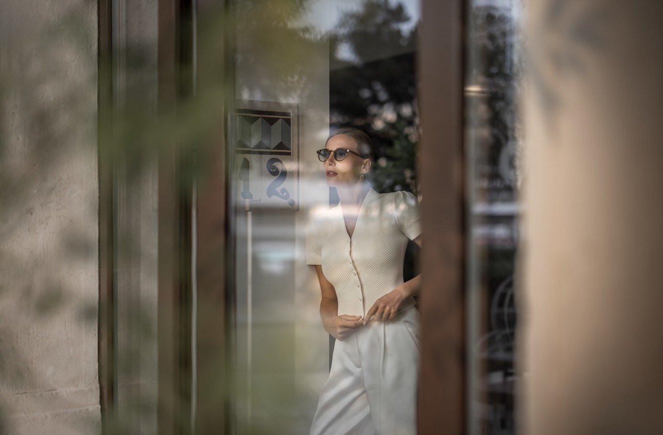A guest stands by a window at Aminess Younique Korcula Heritage Hotel.