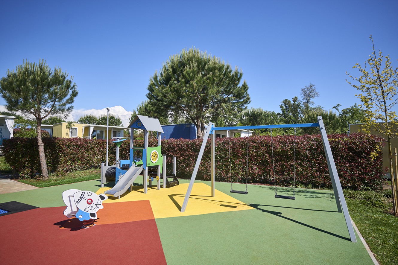 Kinderspeeltuin in het groen in Aminess Planet Camping Maravea.