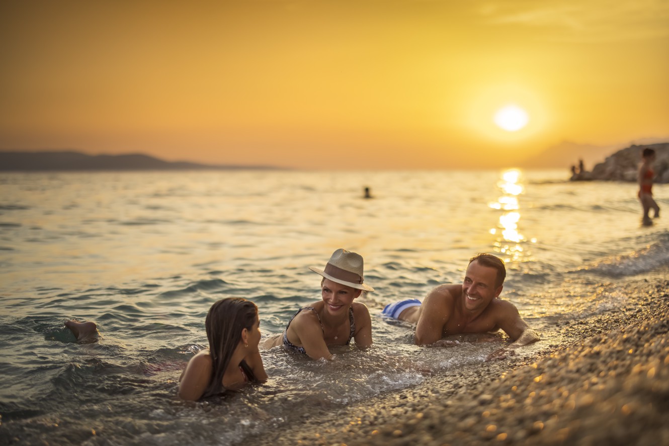 Family in the sea catching up the sun at Aminess Laurel Khalani hotel.