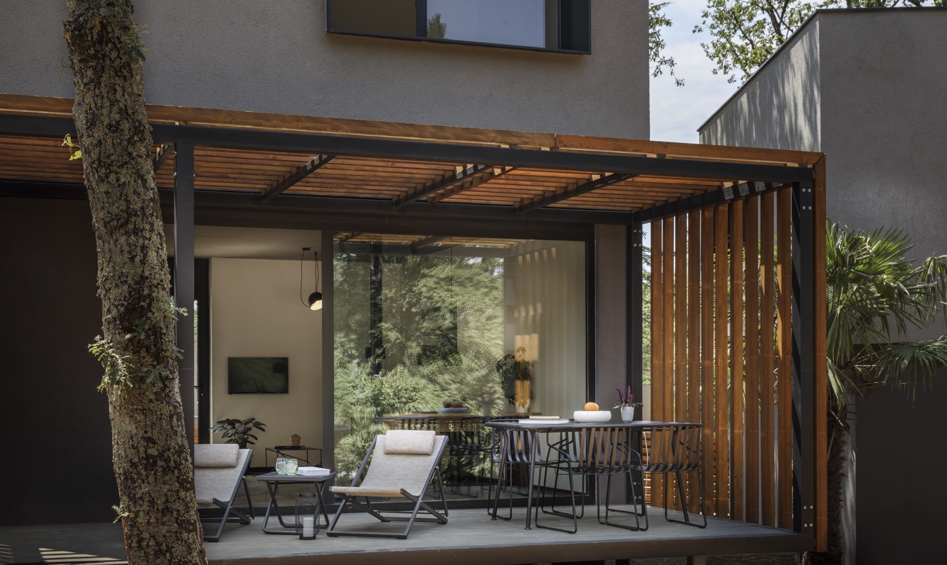 Modern terrace of Aminess Younique Gaia Green Villas in Njivice, featuring a stylish outdoor seating area surrounded by greenery