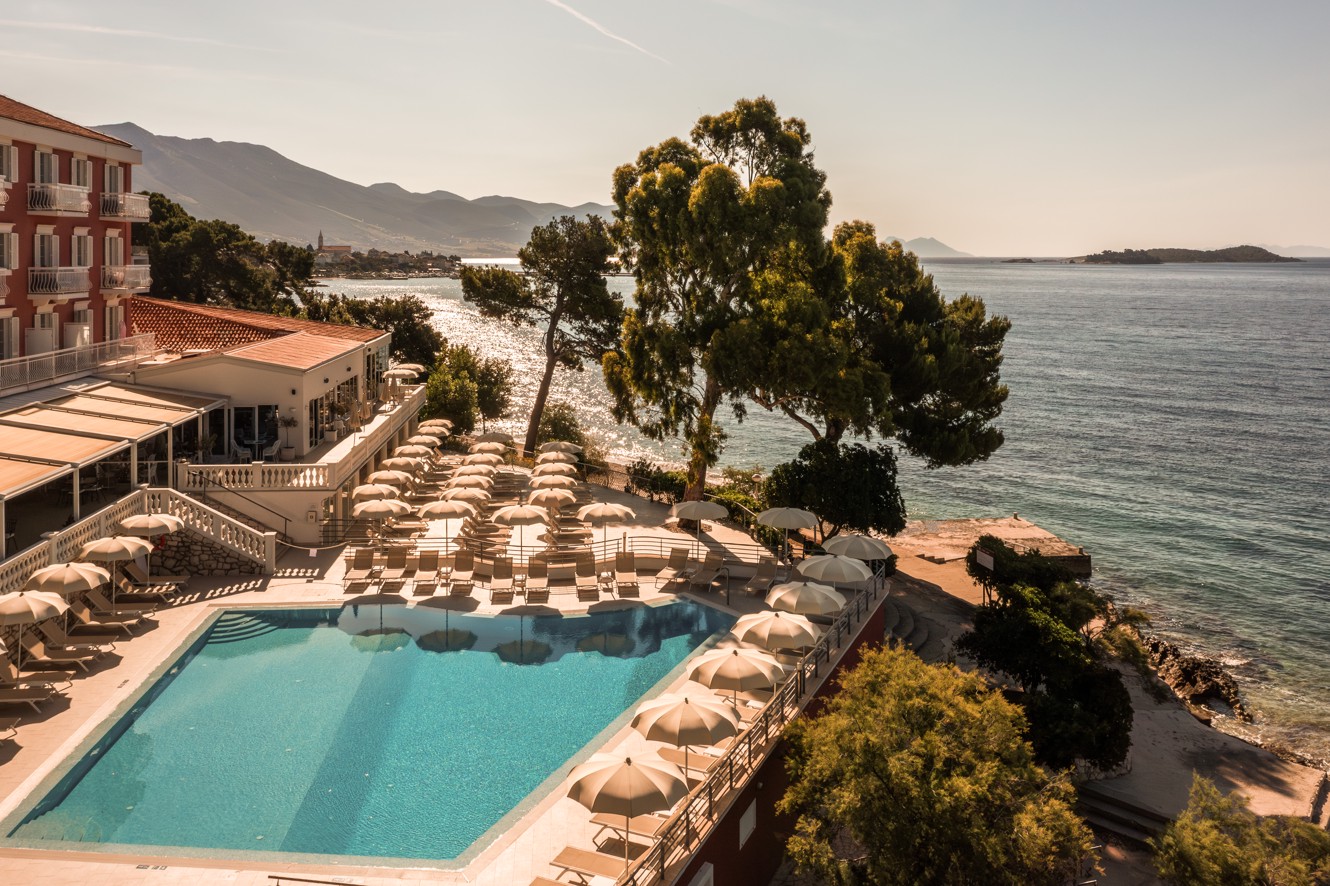 Sun bed are by the hotel pool, pine trees and a beach near Aminess Maradiso Bellevue Village.