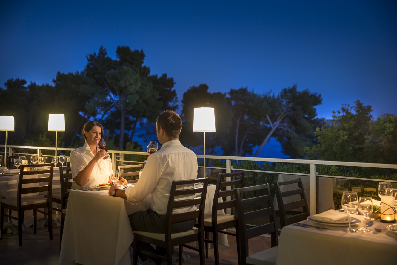 Couple enjoying a candle-lit, night ambience at the restaurant's terrace