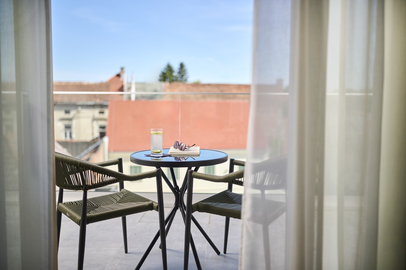 Balcony of a deluxe room at Aminess Florian Godler Hotel with seating.