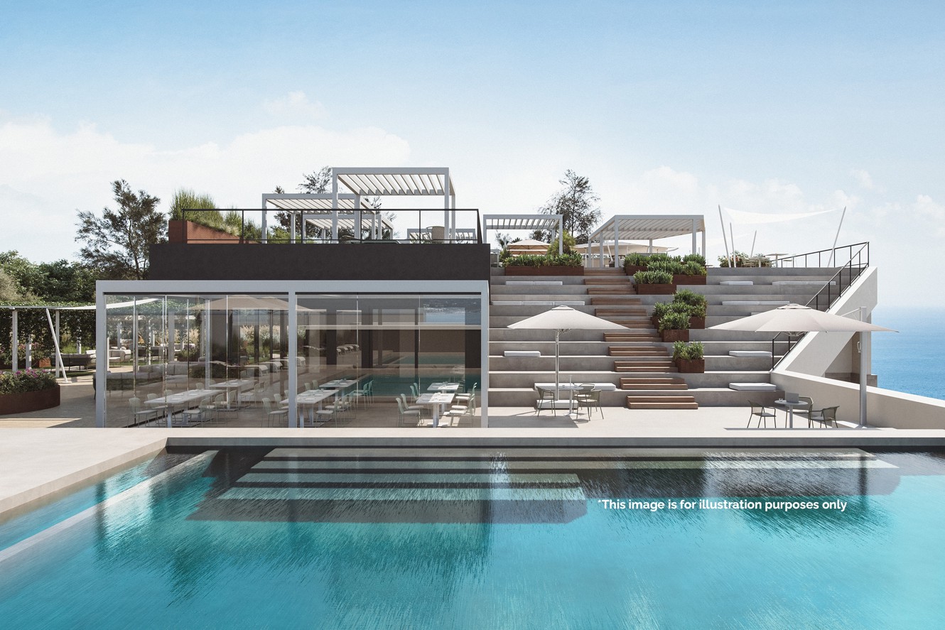 Outdoor infinity pool with terraces and a modern lounge area in a resort setting overlooking the sea