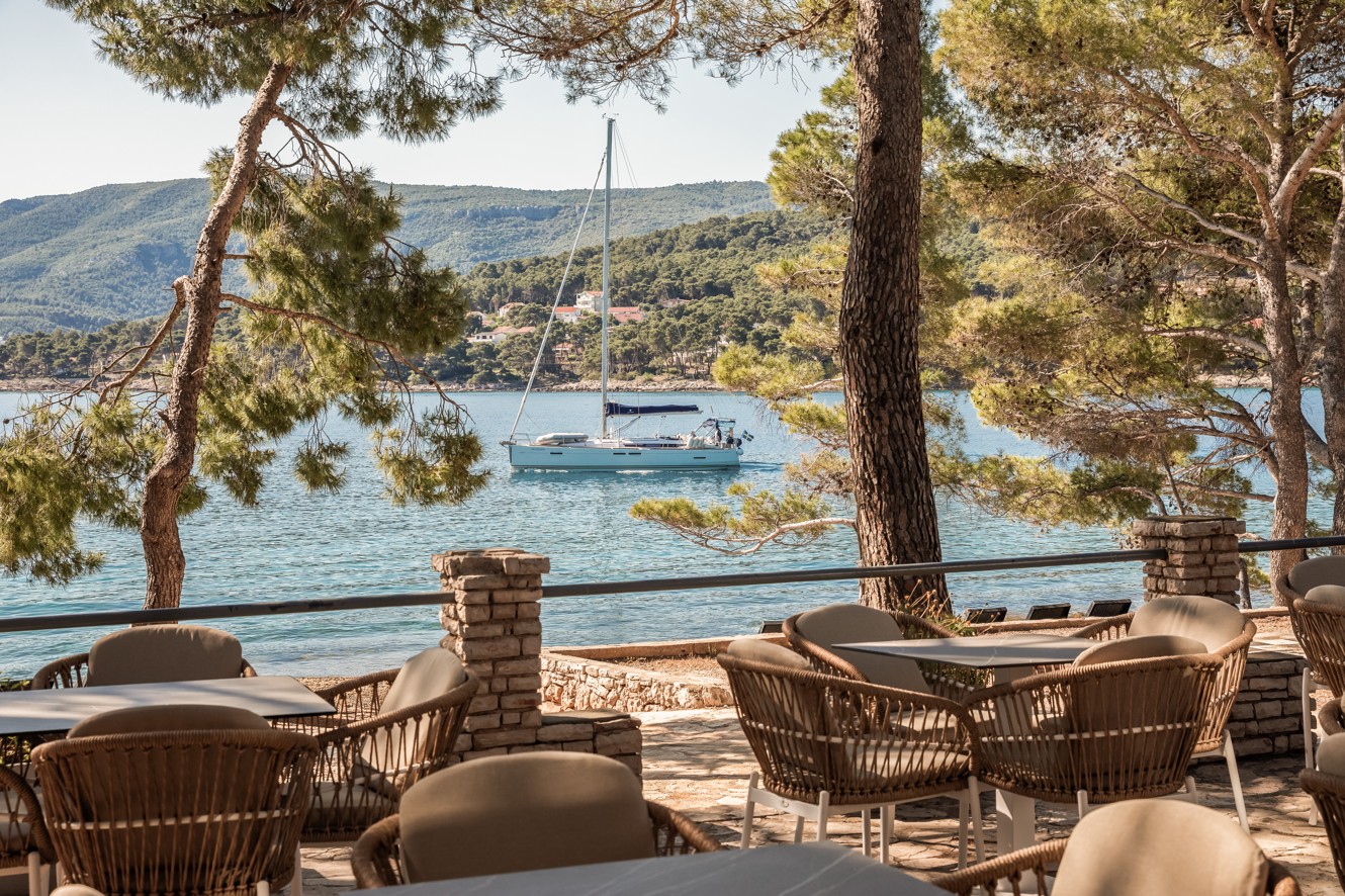 Terrace bar at Aminess Younique Senses Resort on Hvar Island with sea view and yacht in the bay