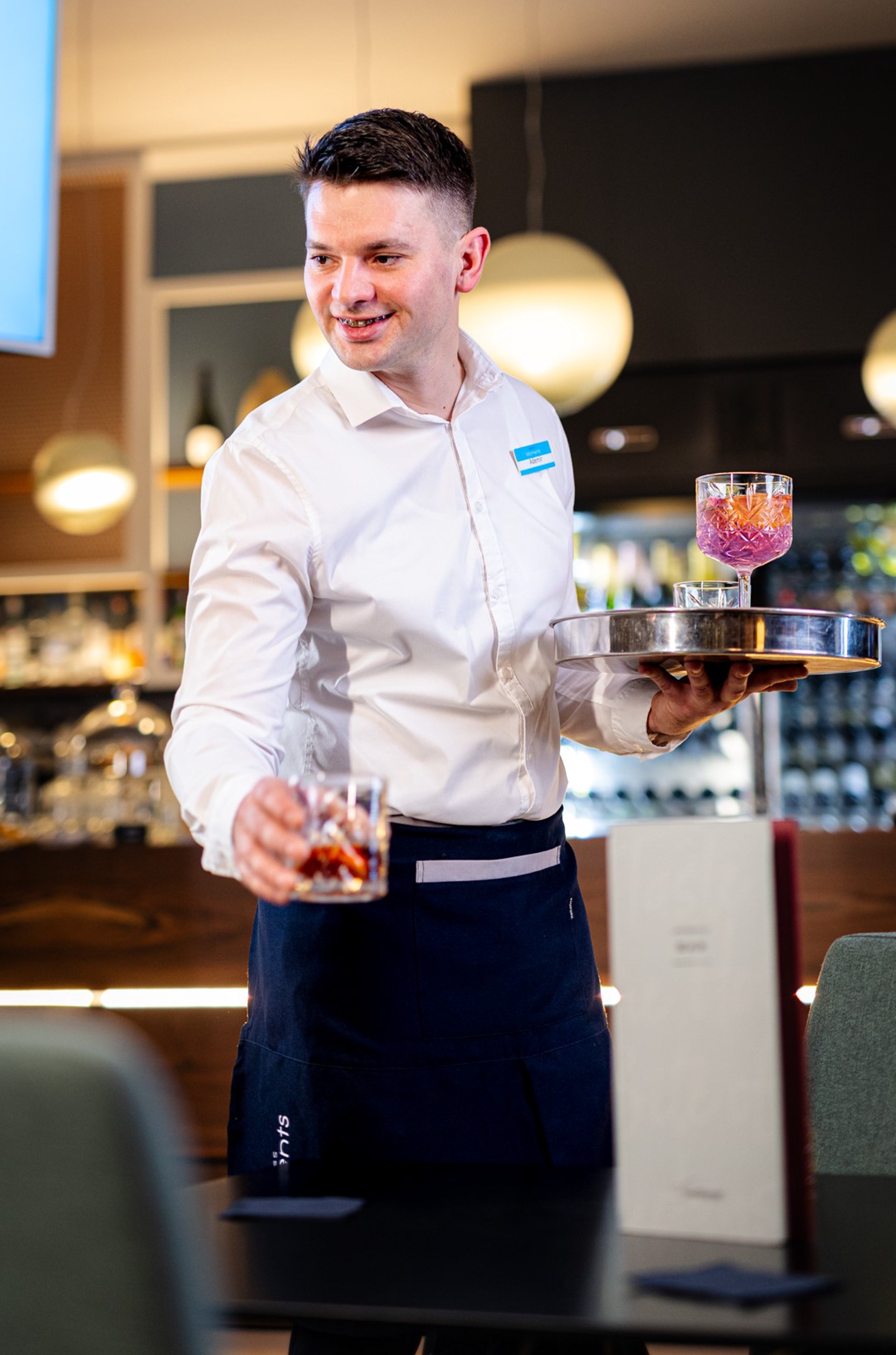 Waitress serving drinks at Aminess